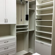 White built in system with pull downs, and a pull out hamper